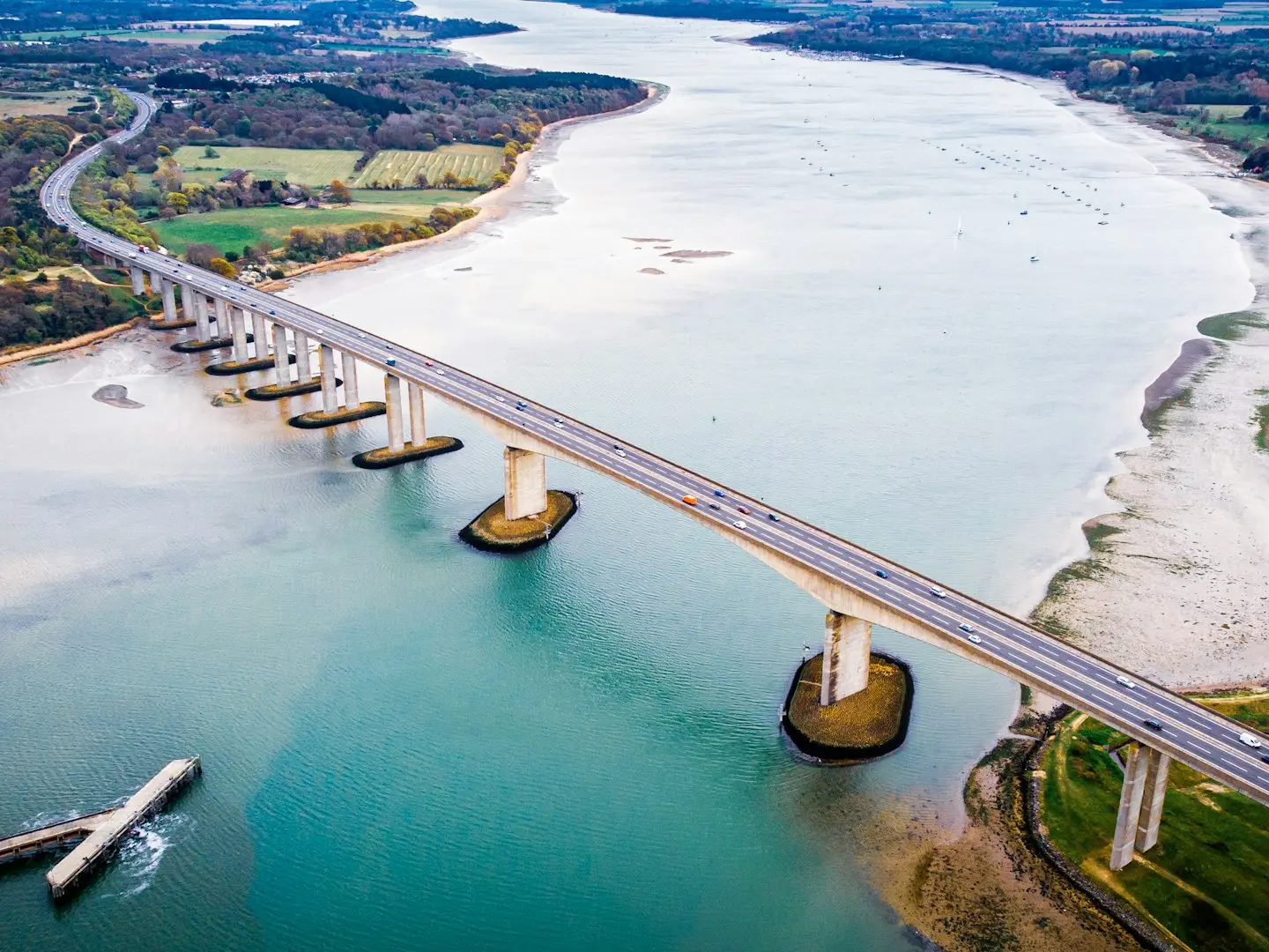 an aerial view of a bridge over a body of water